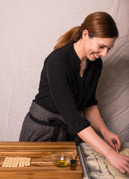 Photo of author Meryl Feinstein in the process of making pasta